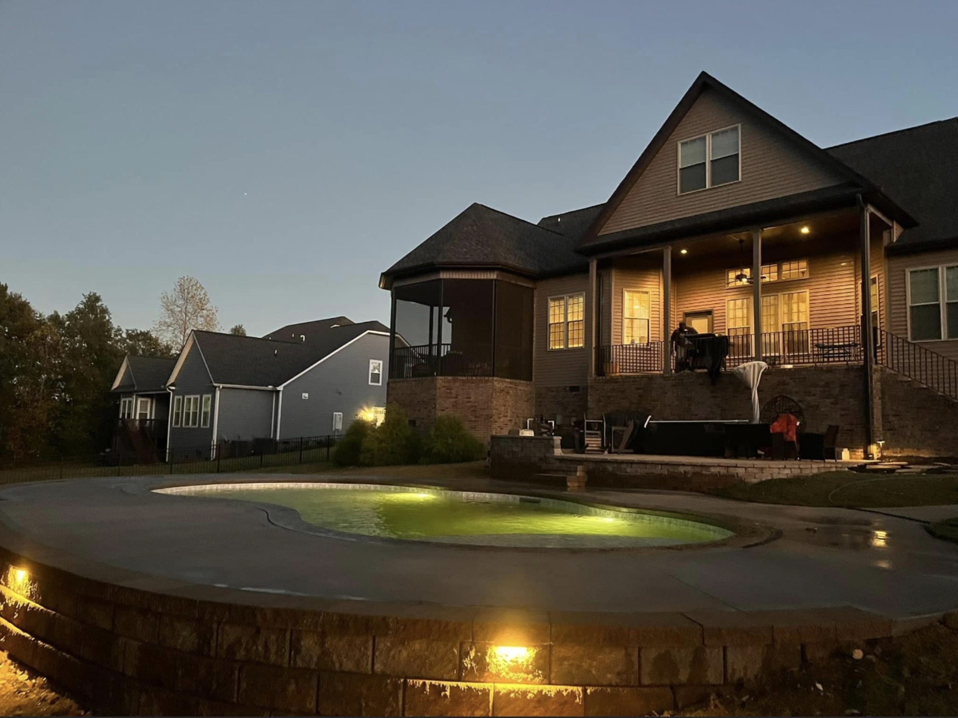 Inground pool with lighting at dusk